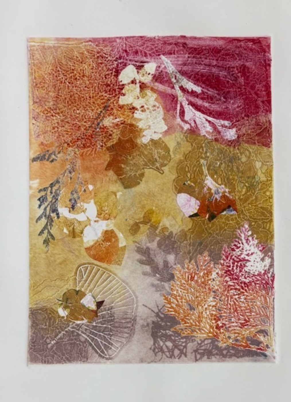 A warm monotype of leaves and lace in reds and golds